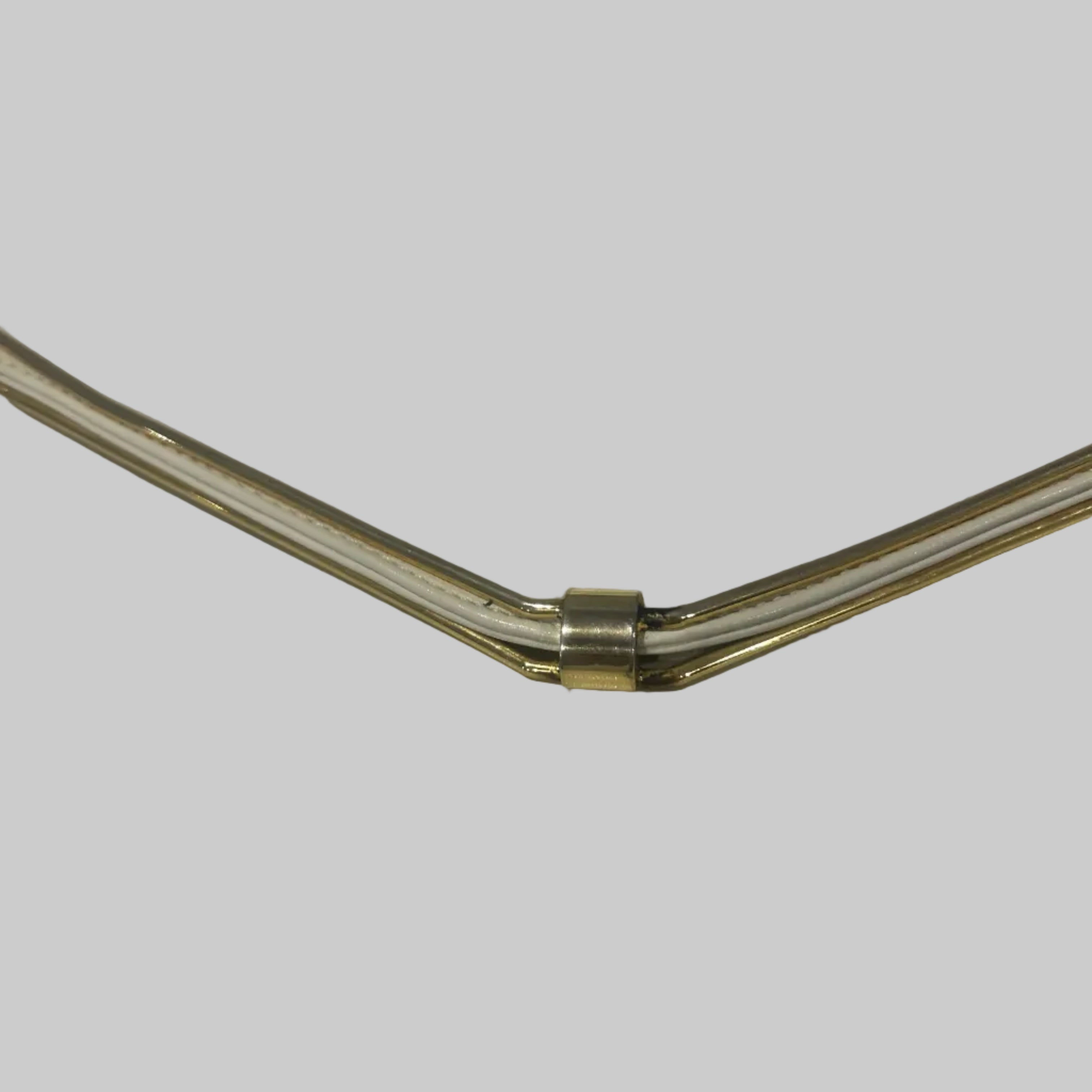 Close-up of a metallic object on a white surface