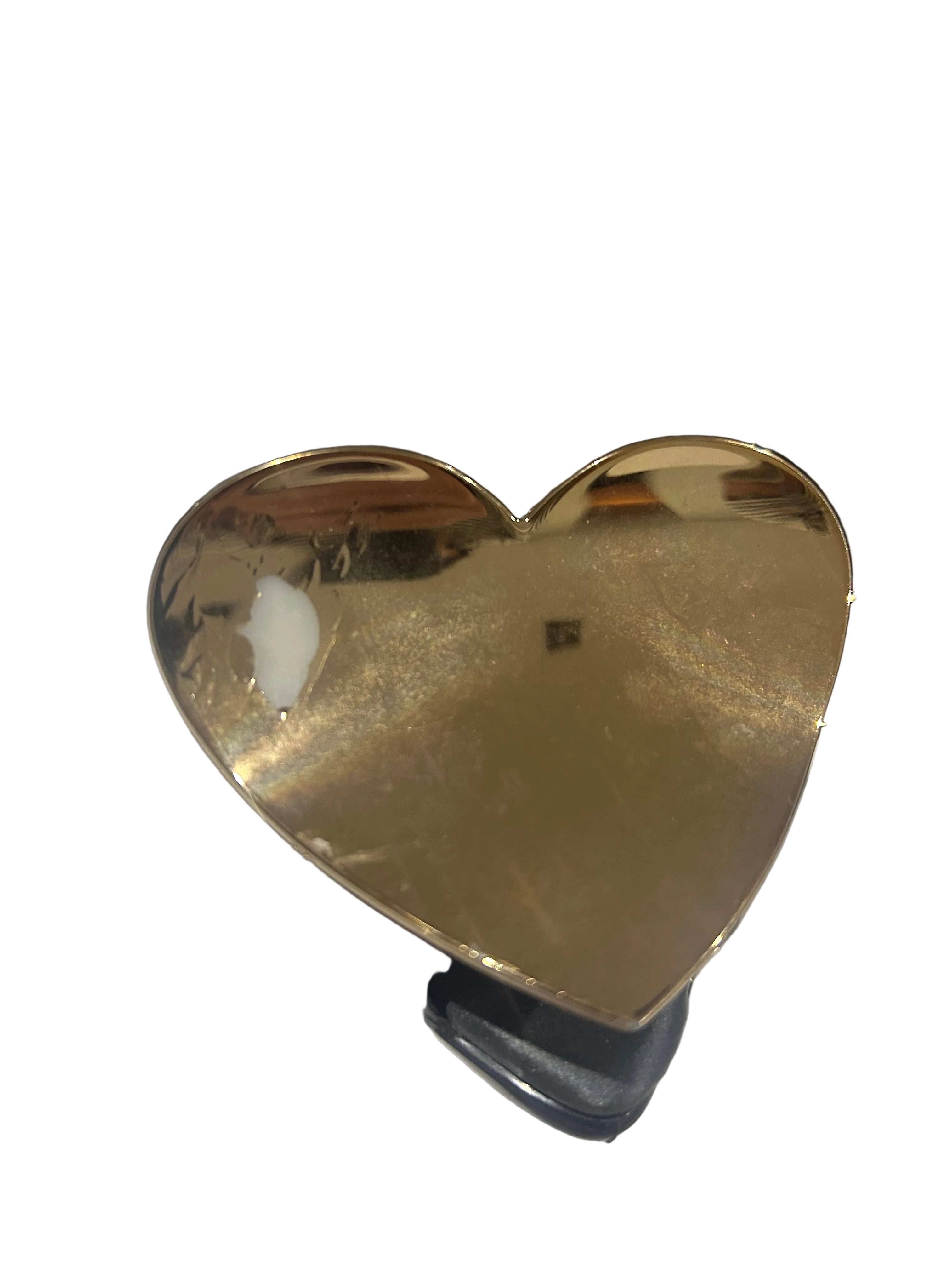 Gold heart-shaped object on a white background