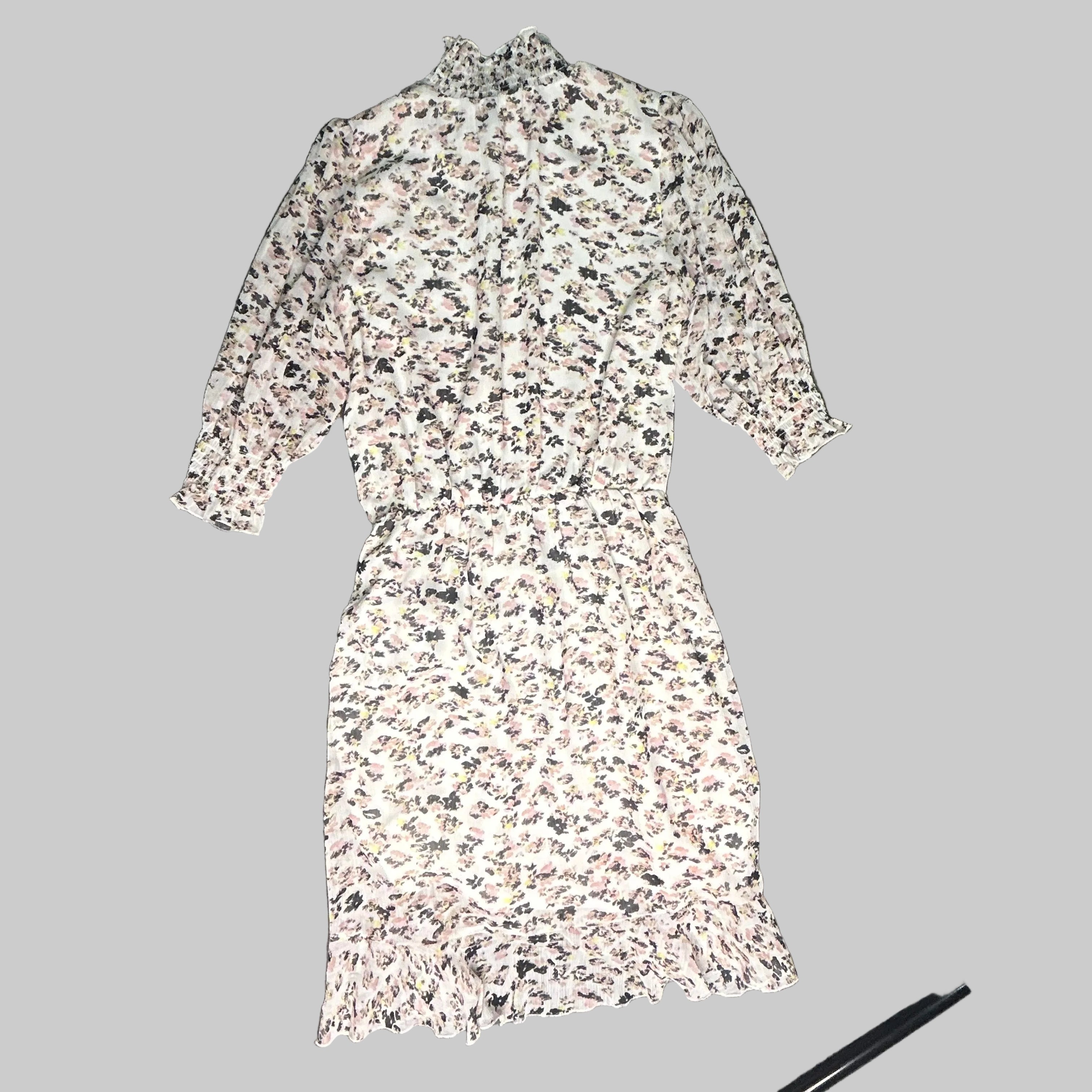 Floral patterned dress on a gray surface