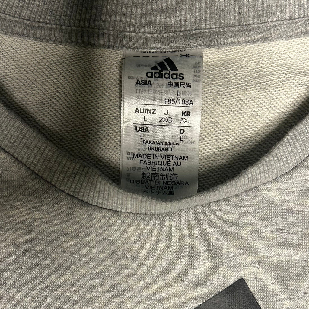 Close-up of Adidas label on a gray fabric background