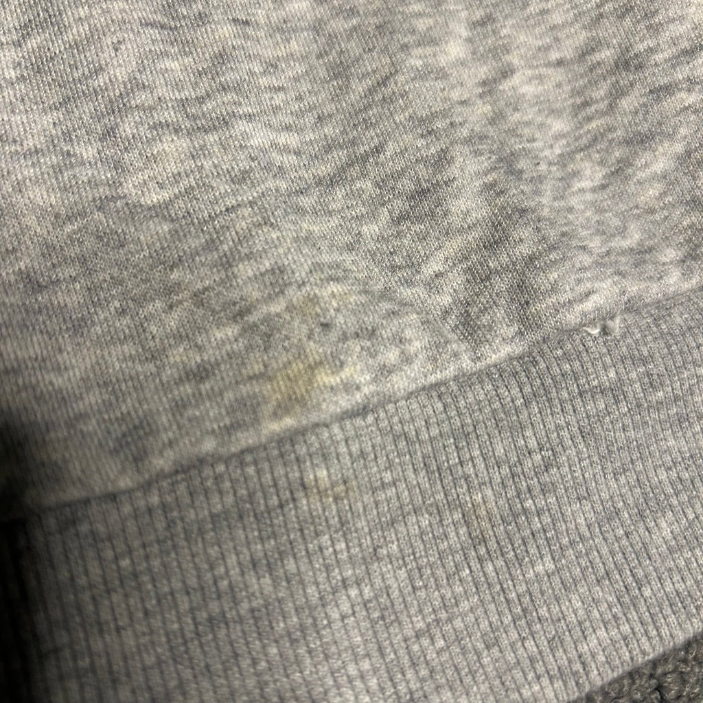 Close-up of textured gray fabric with a visible seam.