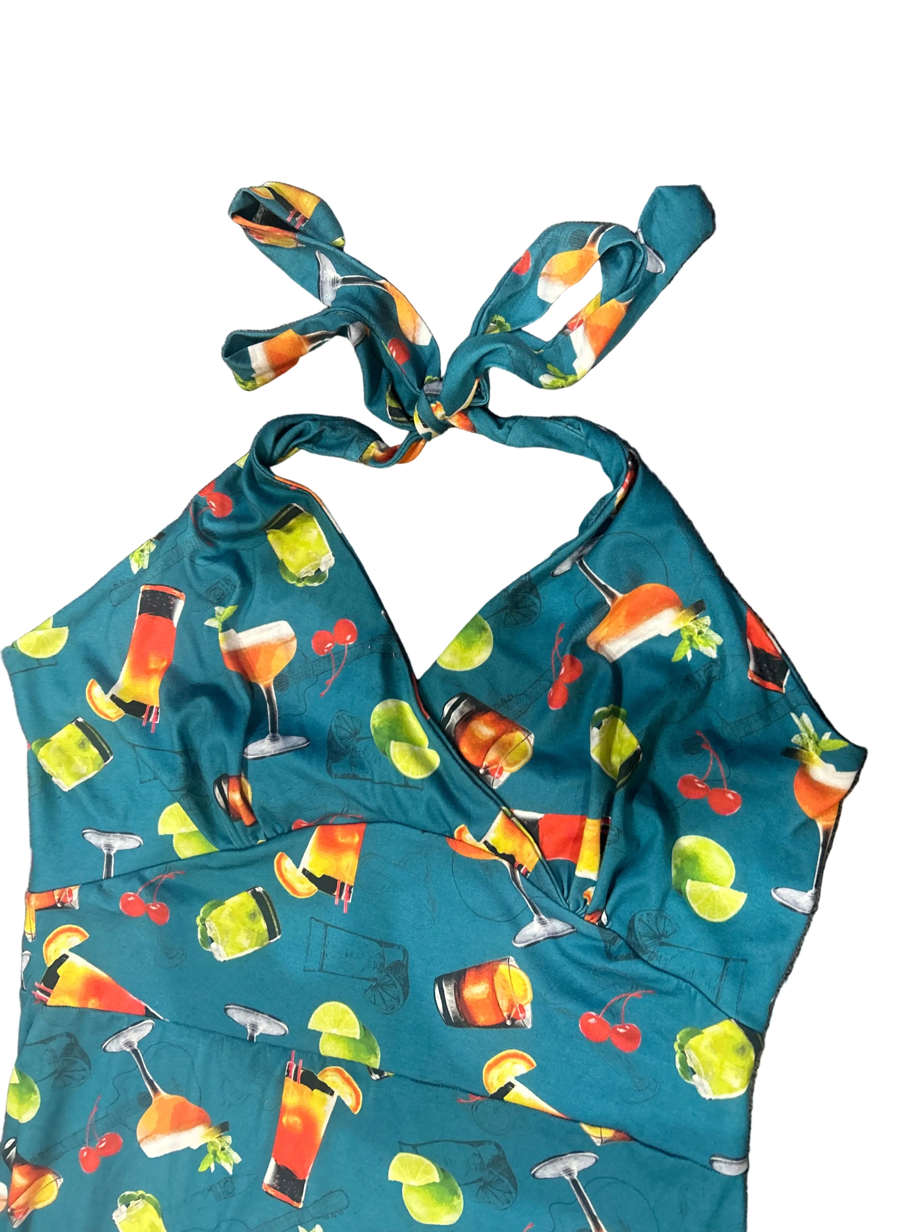 Blue bikini with colorful drink and fruit pattern on a textured surface