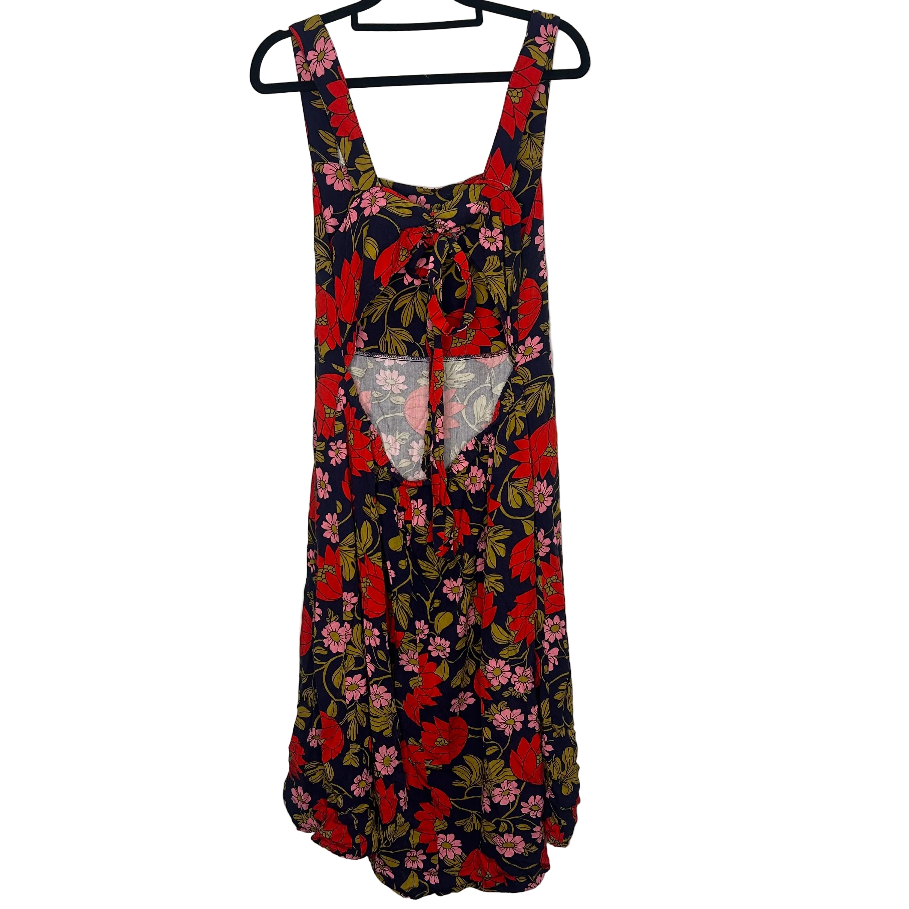 Floral dress on a hanger against a plain background