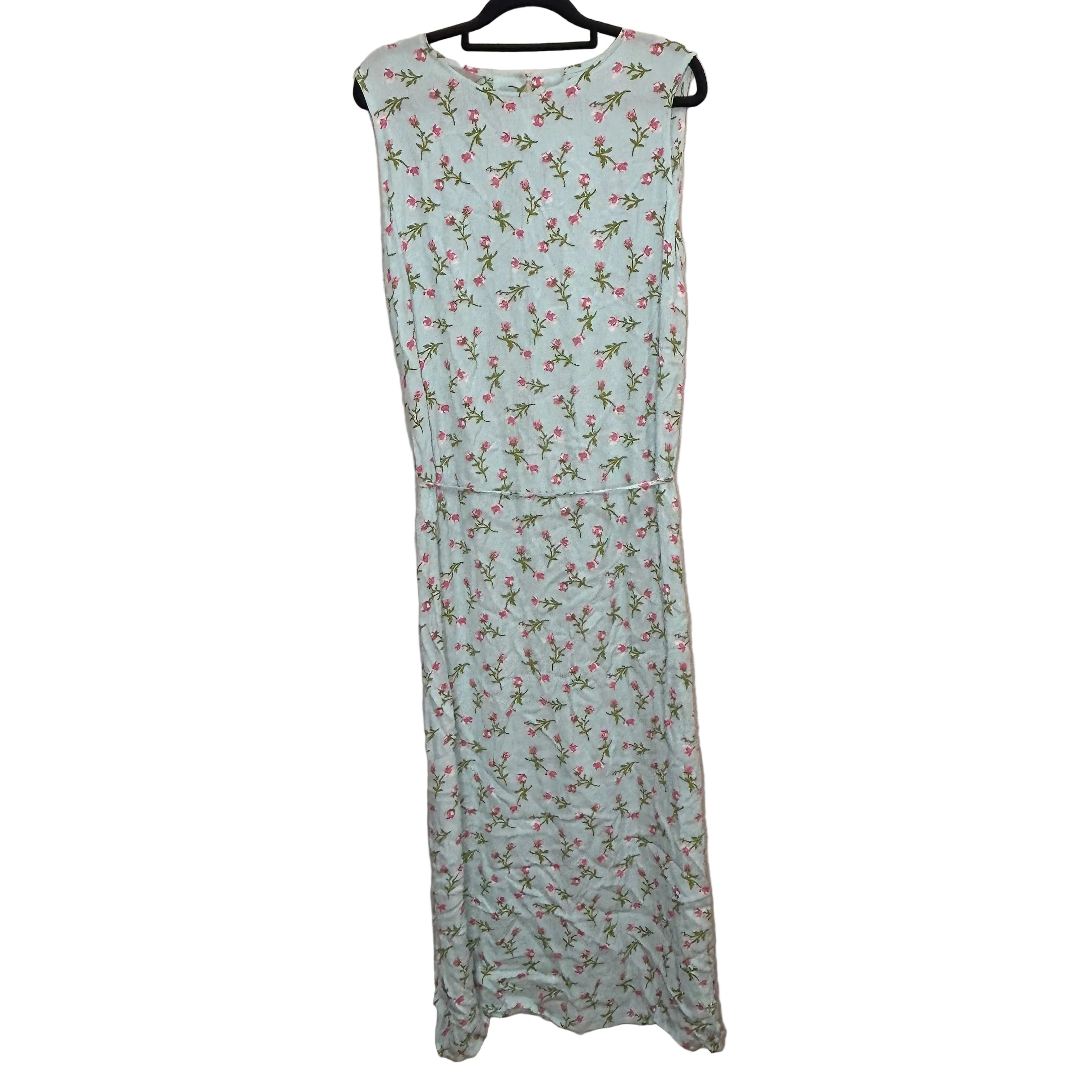 Light blue sleeveless dress with floral pattern on a beige background