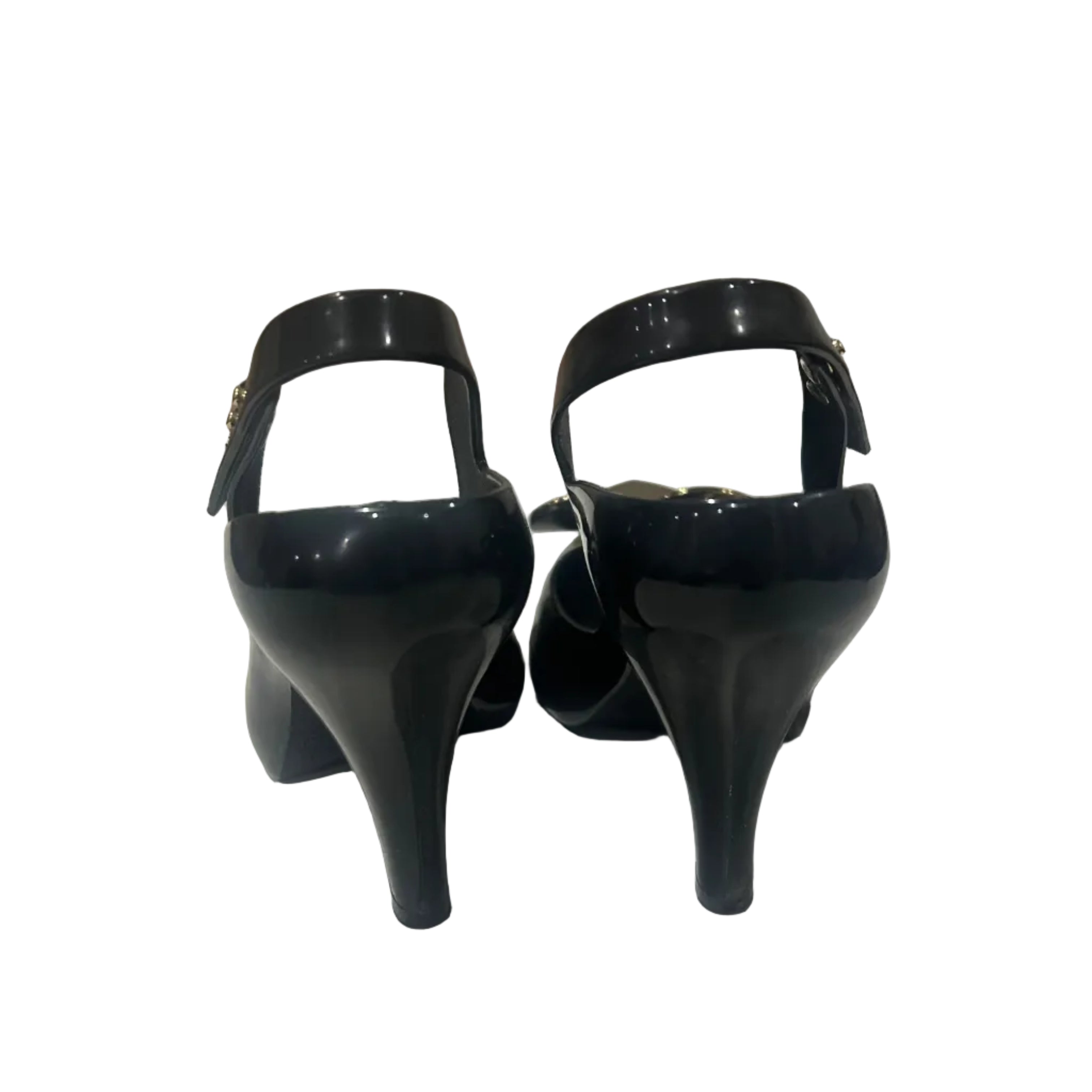 Black high-heeled shoes on a white surface with a neutral background