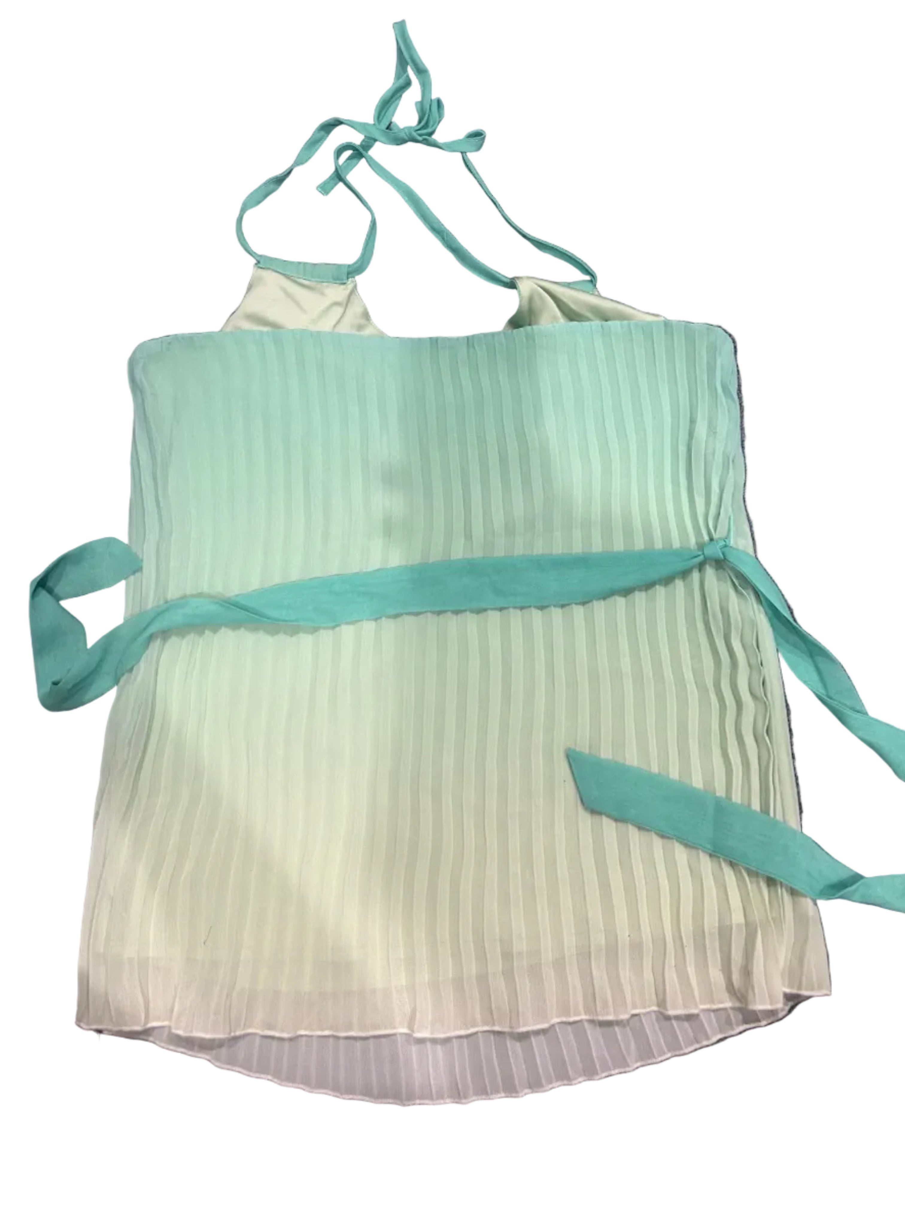 Light green top with thin straps on a dark purple background
