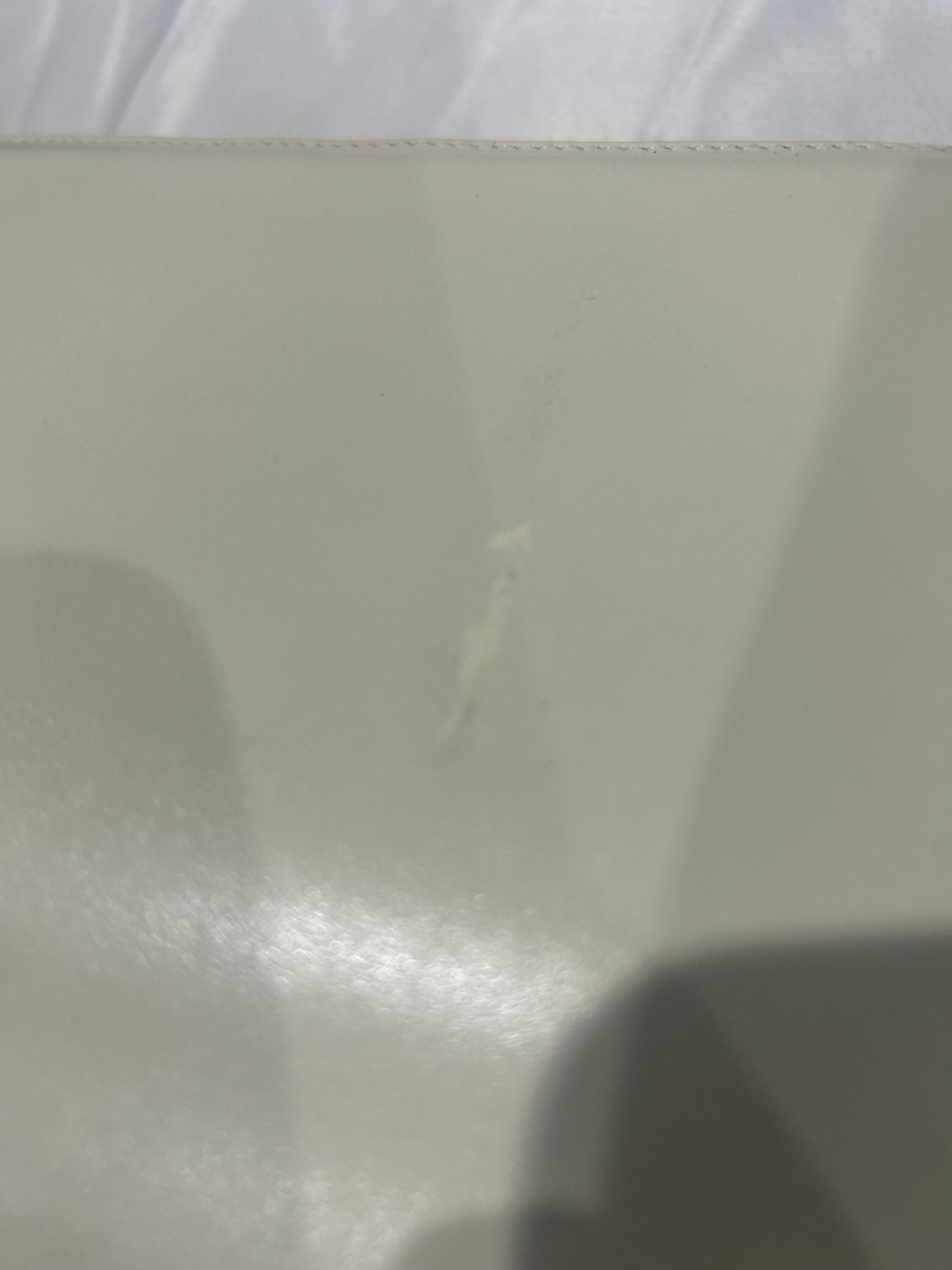 Close-up of a textured white surface with a shadow